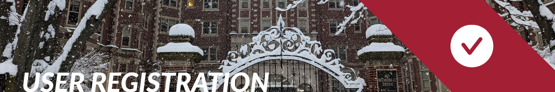 Image of Maseeh Hall outside during the winter with snow on the metal gate with words "User Registration"